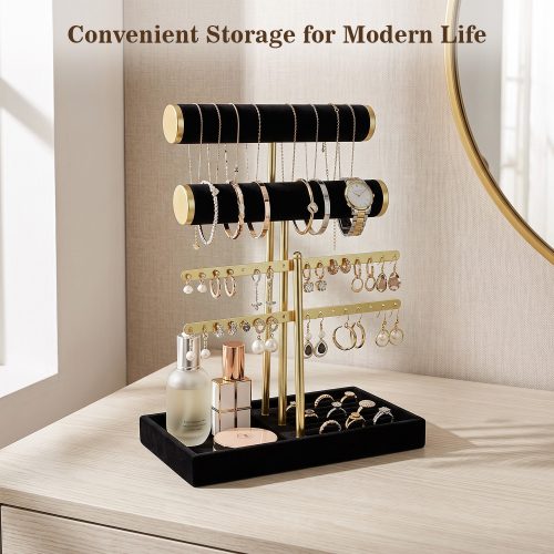 Elegant black gold jewelry holder stand on light wood dresser with full jewelry collection and beauty products